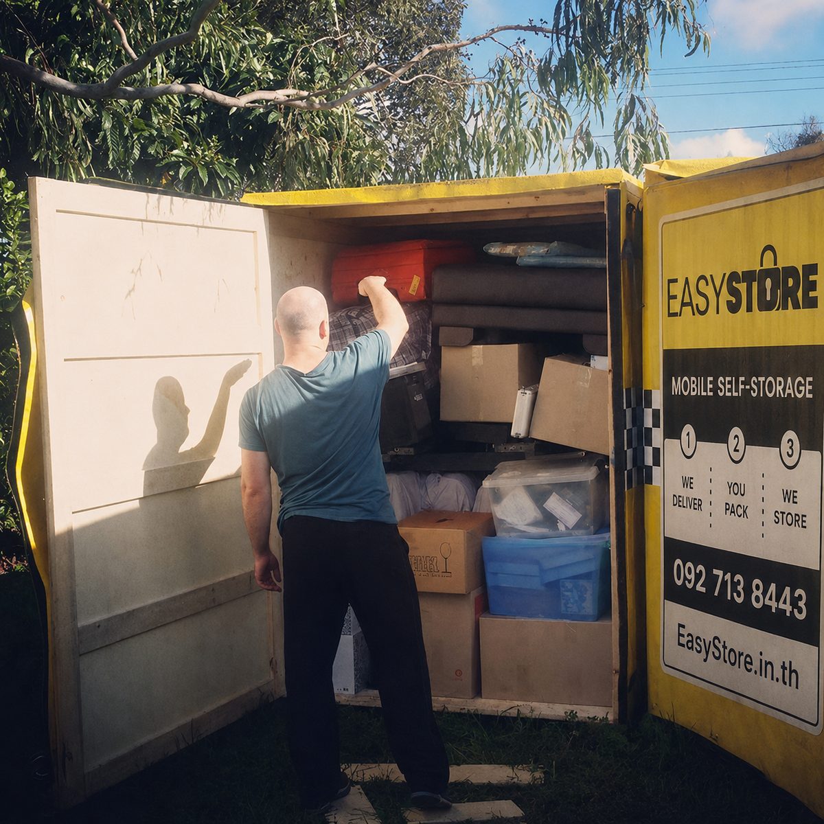 Man packing boxes and furniture into an EasyStore self storage box at his own pace